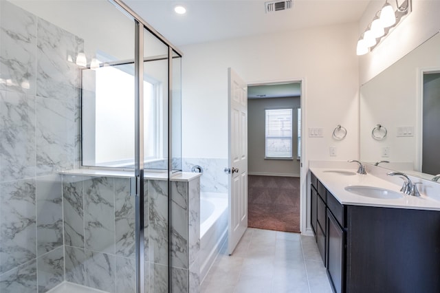 bathroom with vanity, tile patterned floors, and plus walk in shower