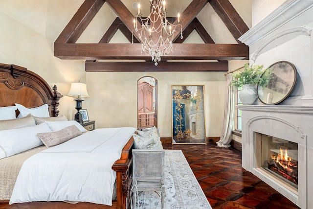 bedroom with a chandelier, high vaulted ceiling, a premium fireplace, and beamed ceiling