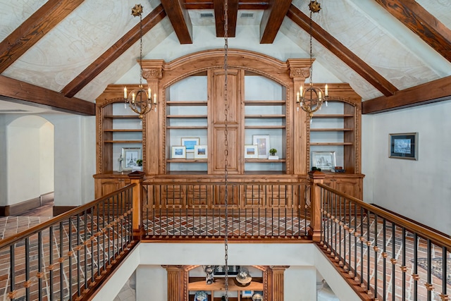 living room featuring built in shelves, beam ceiling, a chandelier, and high vaulted ceiling