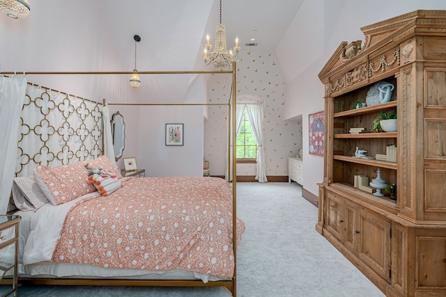 bedroom with an inviting chandelier, light colored carpet, and high vaulted ceiling