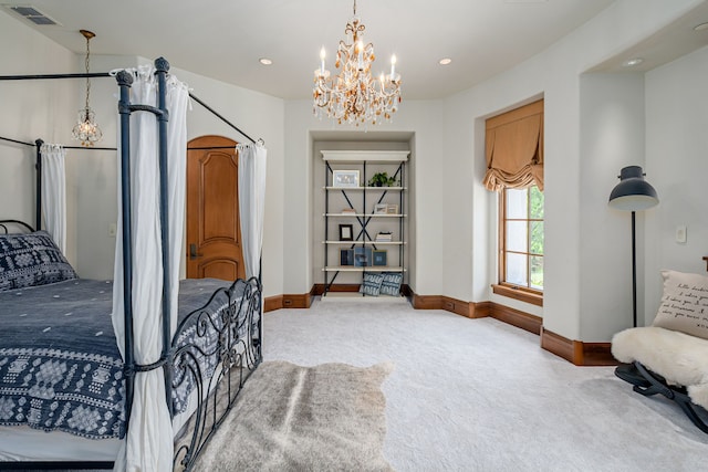 carpeted bedroom featuring a chandelier