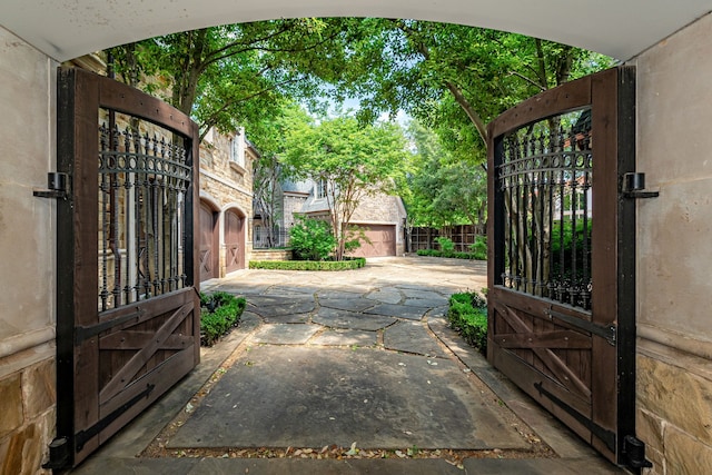 view of gate with an outbuilding