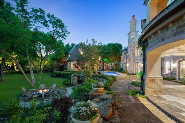 view of yard featuring a fire pit and a patio area