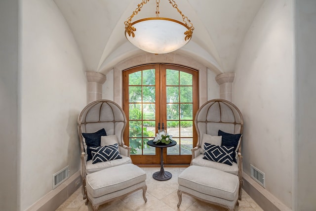 living area featuring french doors and lofted ceiling