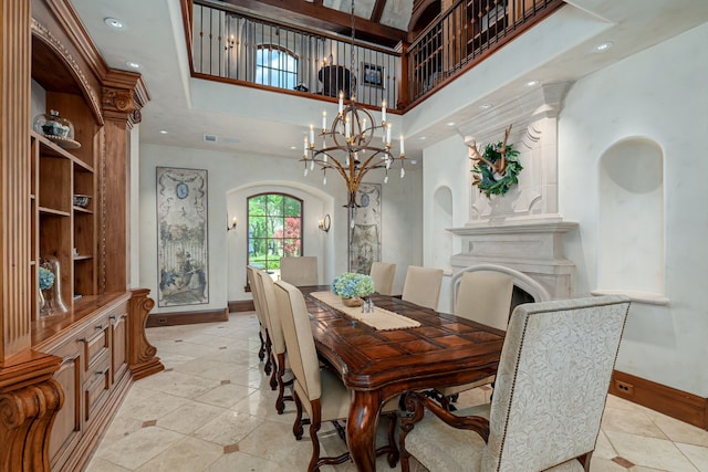 dining area with a towering ceiling and a notable chandelier