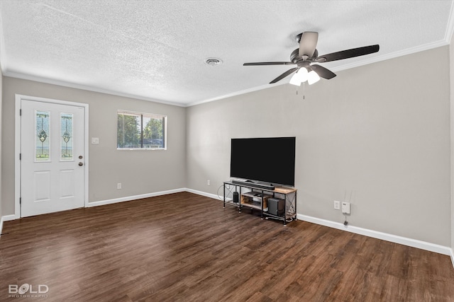 unfurnished living room with ceiling fan, dark hardwood / wood-style flooring, ornamental molding, and a textured ceiling