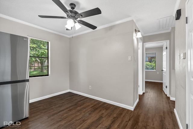 spare room featuring a textured ceiling, dark hardwood / wood-style floors, ceiling fan, and crown molding