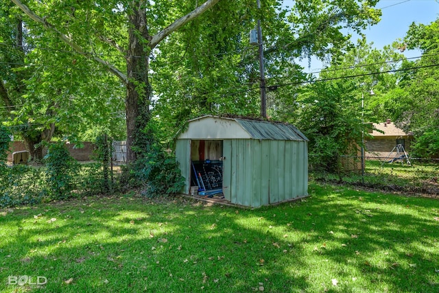 view of outbuilding with a lawn