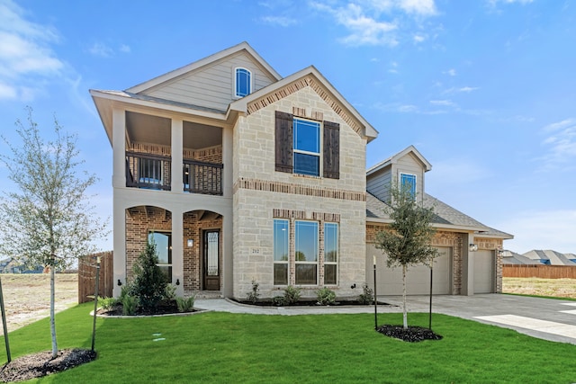 view of front of home with a balcony, a garage, and a front yard