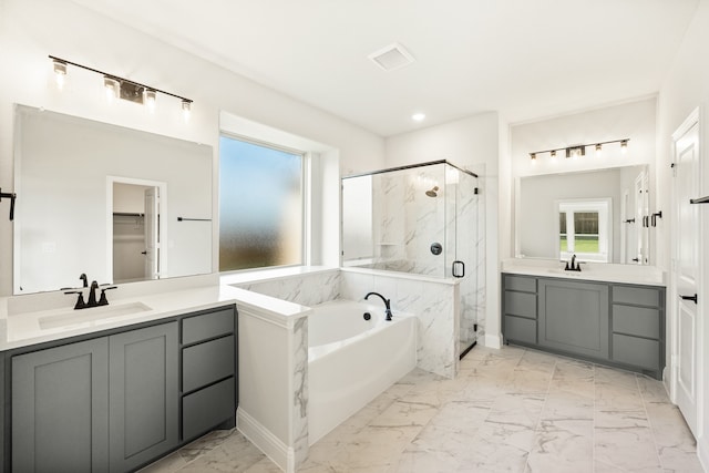 bathroom featuring vanity and shower with separate bathtub