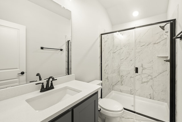 bathroom with a shower with door, vanity, lofted ceiling, and toilet