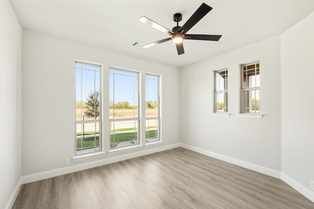 empty room featuring ceiling fan and light hardwood / wood-style floors