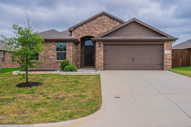 single story home featuring a front yard and a garage