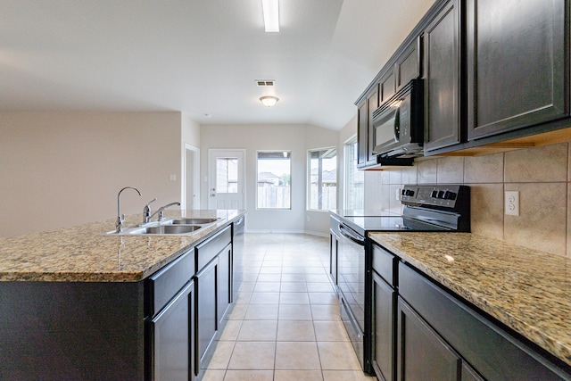 kitchen with light stone counters, range with electric cooktop, light tile patterned flooring, tasteful backsplash, and sink