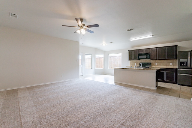 kitchen featuring ceiling fan, fridge with ice dispenser, range, and light colored carpet