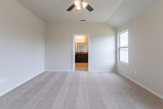 carpeted spare room with ceiling fan and lofted ceiling