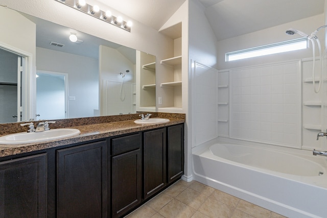 bathroom featuring  shower combination, dual bowl vanity, and tile patterned flooring