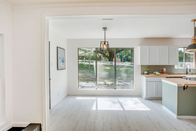 kitchen featuring tasteful backsplash, sink, pendant lighting, and a wealth of natural light