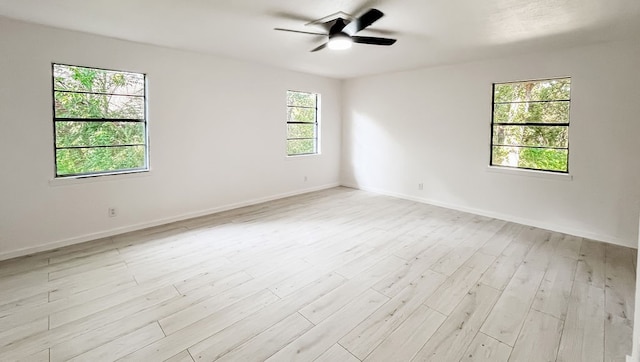 unfurnished room with ceiling fan and light hardwood / wood-style floors