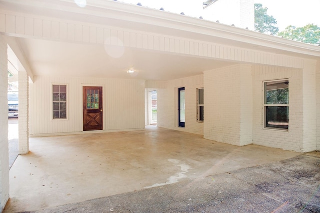 unfurnished room featuring brick wall