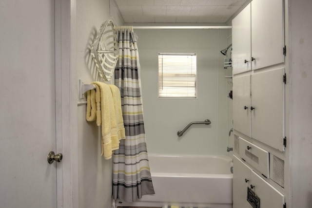 bathroom with shower / bath combo with shower curtain