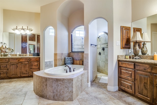 bathroom with vanity and plus walk in shower