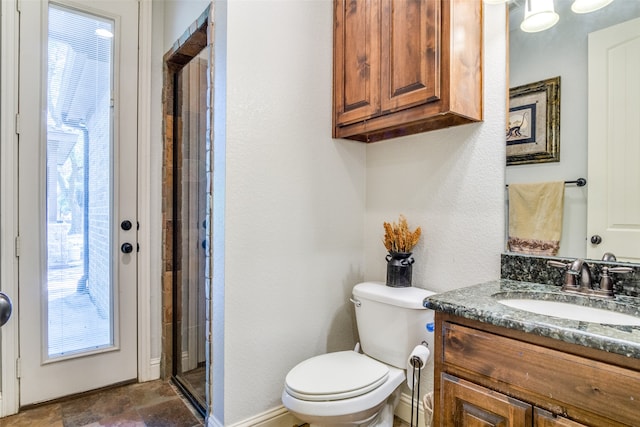 bathroom featuring vanity, toilet, and a healthy amount of sunlight