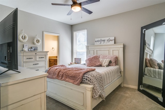 carpeted bedroom with ceiling fan and ensuite bathroom