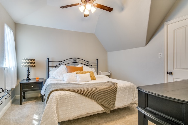 carpeted bedroom with vaulted ceiling and ceiling fan