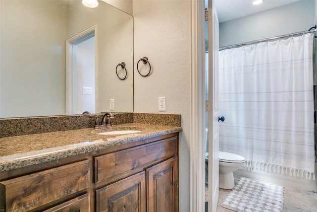 bathroom featuring tile patterned flooring, vanity, and toilet