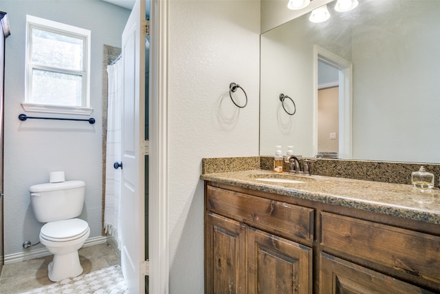 bathroom with curtained shower, tile patterned flooring, toilet, and vanity