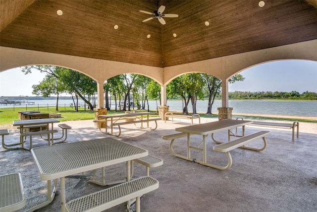 view of community with a water view and a lawn