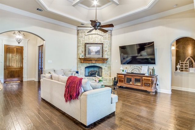 living room with a fireplace, dark wood-type flooring, crown molding, and ceiling fan with notable chandelier