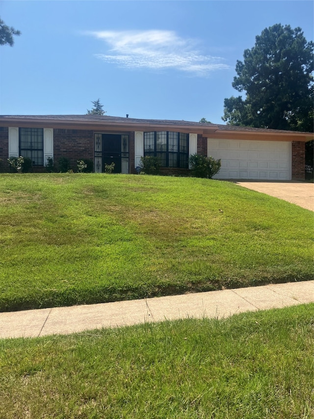 ranch-style home with a front yard and a garage