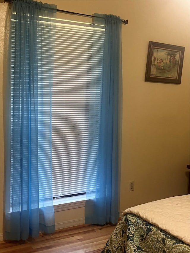 bedroom with hardwood / wood-style flooring