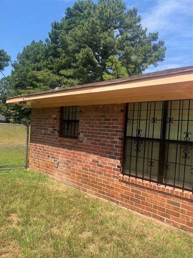 view of side of home featuring a lawn