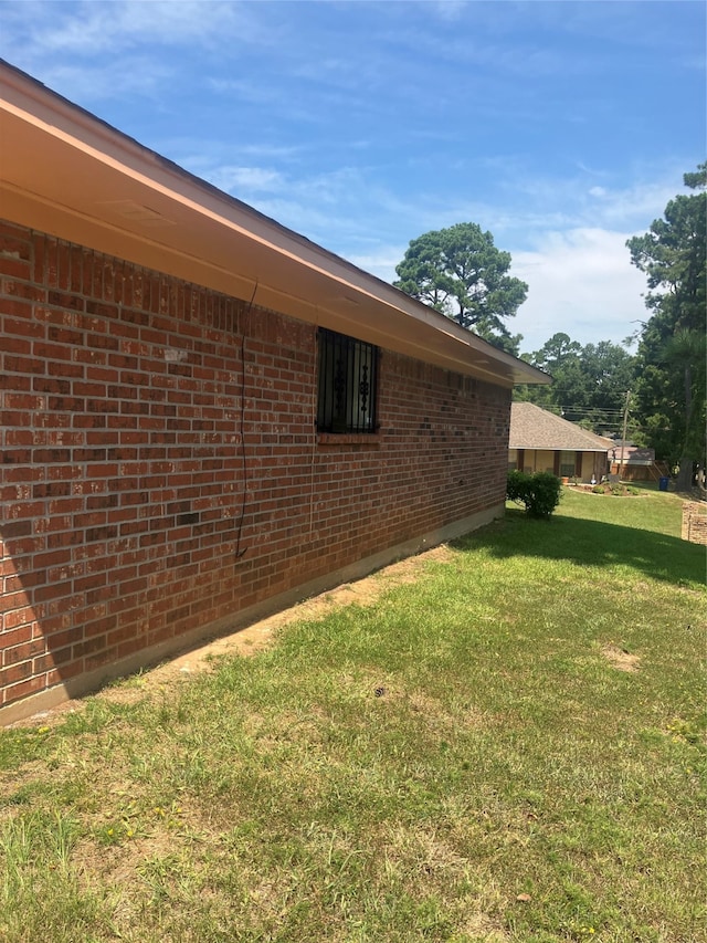 view of side of property with a yard