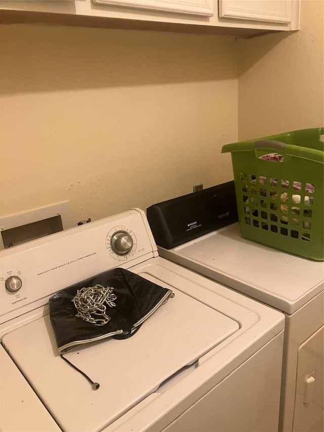 laundry area featuring cabinets and washing machine and dryer