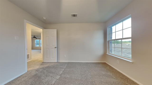 carpeted empty room with ceiling fan