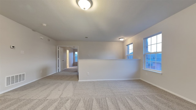 unfurnished room featuring light colored carpet