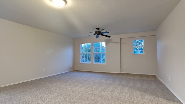 unfurnished room featuring light colored carpet, ceiling fan, visible vents, and baseboards