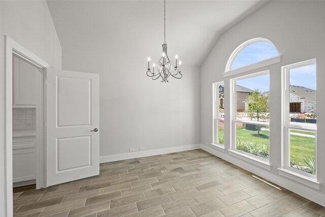 unfurnished dining area featuring high vaulted ceiling, an inviting chandelier, and light tile patterned floors