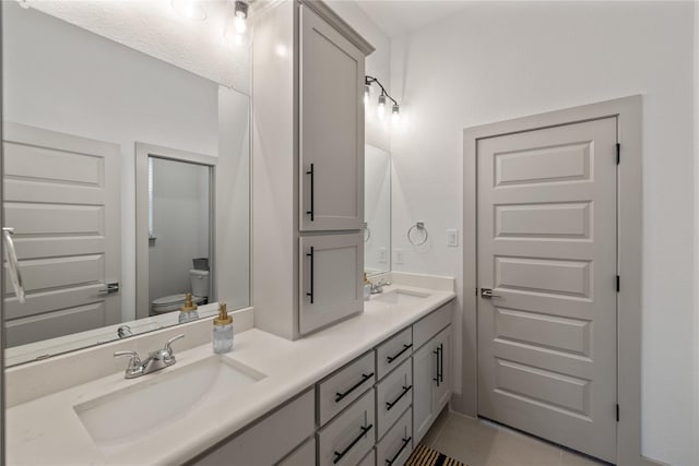 bathroom with tile patterned floors, vanity, and toilet