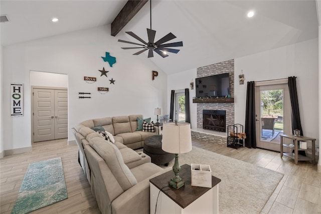 living room with a stone fireplace, ceiling fan, and lofted ceiling with beams