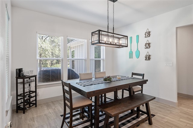 dining space with light hardwood / wood-style flooring