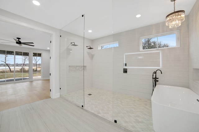 bathroom with ceiling fan, a healthy amount of sunlight, shower with separate bathtub, and tile patterned flooring