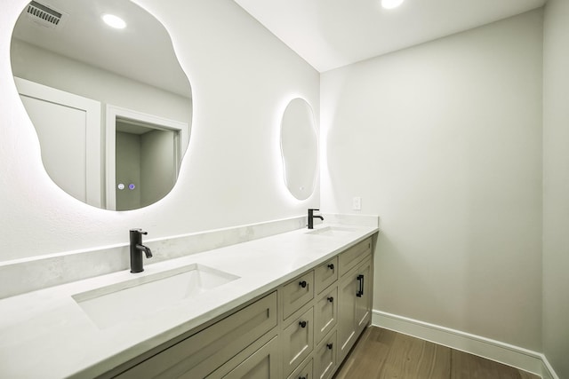 bathroom with vanity and hardwood / wood-style floors