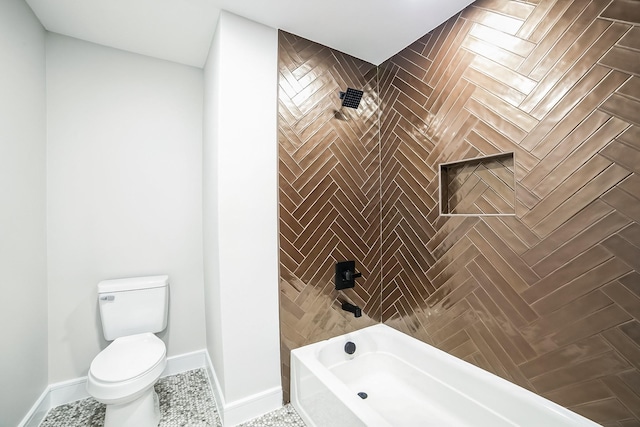 bathroom featuring tiled shower / bath and toilet