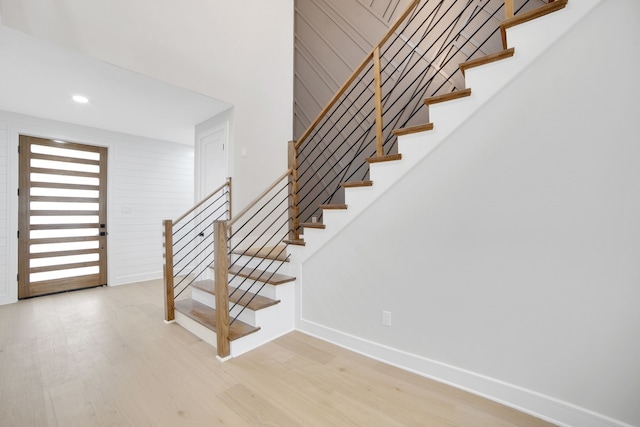 stairway with hardwood / wood-style floors