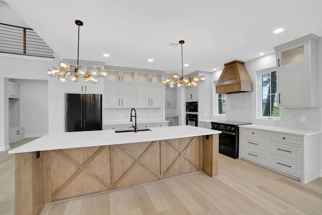 kitchen featuring white cabinetry, black electric range, high end refrigerator, and custom exhaust hood